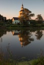 Village church with pond at sunset with reflection Royalty Free Stock Photo